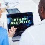 Laptop screen which reads "CYBER SECURITY" in front of Ocean County website designer and client